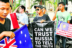 Malaysians protest with placards during a rally demanding justice for the victims of MH17 outside the Russian embassy in Kuala Lumpur on Tuesday