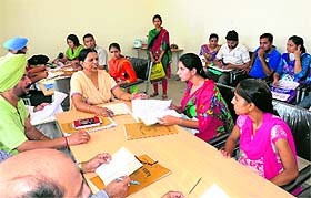 DEO (Secondary) Amarjit Kaur Kotfatta checks certificates of students during the first day of counselling at Special Residential School for Meritorious Students;