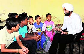 District and Sessions Judge Tejwinder Singh interacts with kids at the childrens home in Bathinda on Wednesday