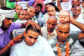 Members of the Patra Adhyapak Sangh during a mundan ceremony performed in protest against the Haryana Government at Sector 5, Panchkula, on Wednesday