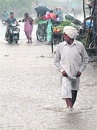 An elderly person wades through a waterlogged road in Ambala City on Wednesday