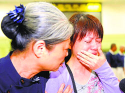 Inconsolable relatives of a passenger on board the crashed TransAsia Airways plane at the Kaohsiung airport in Taiwan on Wednesday