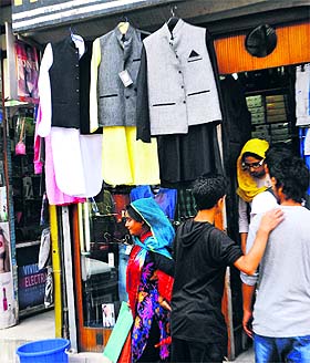 Selection time: Youth looking for a Pathani suit at a busy market in Srinagar on Wednesday