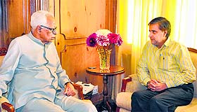 Governor NN Vohra interacts with Minister for Forest Mian Altaf at Raj Bhawan in Srinagar on Wednesday.
