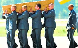 Military men carry a coffin containing the remains of a victim of downed MH17 during a ceremony at Eindhoven Airbase on Wednesday. AFP