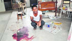 A man shows blood stains at Bhullar Farmhouse in Khuda Lahora, Chandigarh, after the robbery.