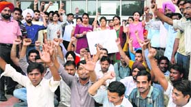Members of the Chandigarh College of Engineering and Technology Employees Union protest in Sector 26, Chandigarh, on Thursday.