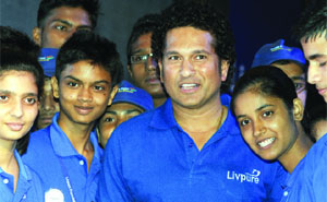 Indian cricketer and Member of Parliament Sachin Tendulkar poses with schoolchildren during a promotional event in New Delhi on Thursday.