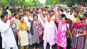 Activists of the Peoples Democratic Party hold a protest in Jammu on Thursday.