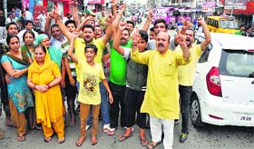 Residents of Janipur protest power crisis in Jammu on Thursday.