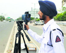 A policeman operates the speed gun in Ludhiana on Thursday