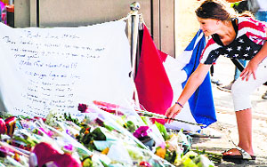 A girl places a flower in memory of MH17 flight victims in Amsterdam on Thursday