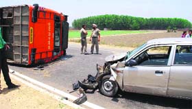 The mangled remains of a bus and a car involved in a high-speed collision on a road in Amritsar.