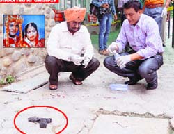 Forensic experts examine the spot at the GMSH, Sector 16, Chandigarh, on Friday. The service pistol (encircled) used in the crime is also seen. Tribune photo: S Chandan. (Inset) A file photo of the accused constable, Anand Kumar, and his wife Dimple 