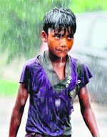 A boy drenched in rain in Dehradun on Friday.