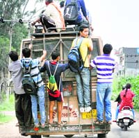 An overloaded mini-bus plies at the Murh block of Jammu. Tribune photo: Anand Sharma