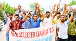 Members of the All Selected Candidates of Warden in Jail, Police and Prison Department stage a protest in Jammu on Friday. Tribune photo: Anand Sharma