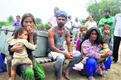 Members of a flash flood-affected family in the Marh block. A Tribune photograph 