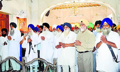Members of various Sikh organisations offer prayers at Akal Takht in Amritsar on Friday.