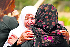 Relatives of Lebanese passenger Mohamed Akhdar, who was aboard the Air Algerie plane that crashed over Mali, mourn at the familys home in the village of Zrairiyeh, Lebanon, on Friday.