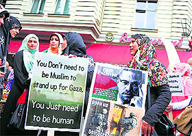 Demonstrators hold placards during a protest against the Israeli assault on the Gaza Strip, in Berlin on Friday.