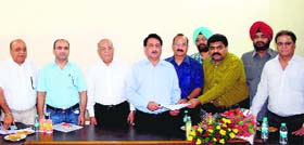 Members of various industrial associations hand over a memorandum outlining their demands to a senior official of Punjab State Power Corporation Limited in Amritsar.