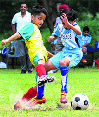 Players in action during a football match between St Xaviers School and St Kabir School at Sector 26, Chandigarh, on Saturday