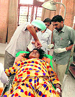 The victim, Dharmo Devi, being treated at a hospital.
