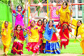 Students of Smart Wonders School have fun during Teej celebrations on the school campus in Mohali on Saturday.