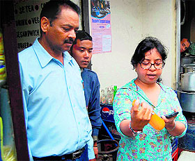 Food Safety and Standard Officer Rachna Lal inspects a cold drink bottle in Mussoorie on Friday.