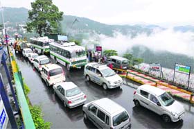 Vehicles stand in a long queue during rain in Shimla on Saturday
