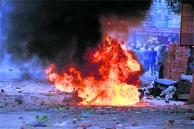 A motorcycle set afire during communal clashes in Saharanpur on Saturday