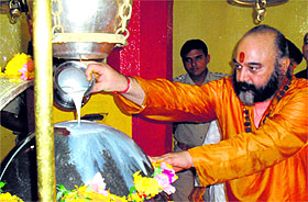 Mahant Deependra Giri performs puja at the Shankaracharya temple in Srinagar on Saturday.
