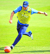 MS Dhoni kicks a football during the nets session at the Ageas Bowl in Southampton.