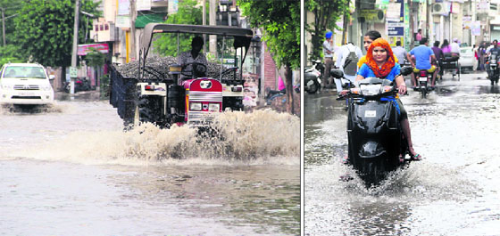 City residents make their way through waterlogged streets after a downpour in Bathinda on Sunday.