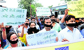 Contractual polytechnic teachers hold a protest at the Parade Ground in Dehradun on Sunday.