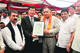 Tibetan PM Lobsang Sangay being honoured by state Transport Minister GS Bali at Nagrota Bagwan on Sunday