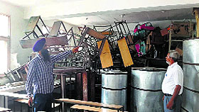 Deputy District Education Officer Dr Charanjit Singh examines a store room of a school.