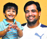 Punjab Police constable Rajwinder Kaur's husband Kuljinder SIngh with his son Gurvansh in a cheerful mood in Jalandhar on Sunday