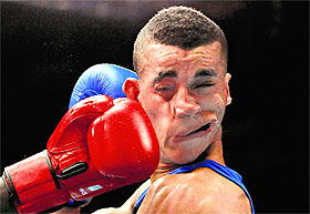 Kenya's Denis Okoth lands a punch on England's Samuel Maxwell during their men's Light Welterweight fight on Sunday. 