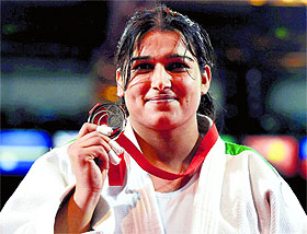 Rajwinder shows her bronze medal that she won beating a Kenyan opponent who was 55kg heavier than her.
