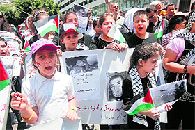 Palestinian children hold placards during a demonstration in support of the children of the Gaza Strip, in Nablus on Sunday.