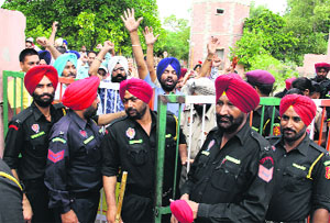 Police commandos stopping activists of the ETT Union from coming out of the Childrens Park to protest in Bathinda on Monday