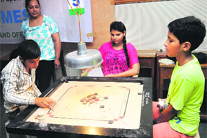 Players in action during the 24th State Carrom Championship at St Stephens School in Sector 45, Chandigarh.