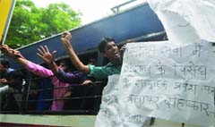 Students being detained by the police shout slogans as they protest against the introduction of CSAT in Civil Services exams, outside the UPSC in New Delhi on Monday. Tribune Photo