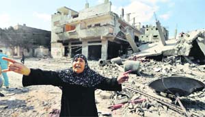 A Palestinian woman reacts as she stands amidst destroyed homes in the Shejaia area that was hit by the Israeli offensive. Reuters