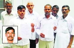 The family of Suresh Kumar (inset) at the Mini-Secretariat in Kurukshetra on Monday. Tribune photo