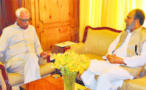 Governor N N Vohra meets Baramulla MP Muzaffar Hussain Baig at Raj Bhawan in Srinagar on Monday.