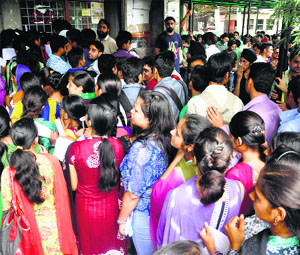 Students stand in long queues for depositing exam fee at counters in the University of Jammu on Monday.
