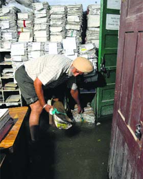 An employee drains out rainwater from the basement of the Mini-Secretariat in Ludhiana